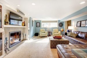 Comfortable family room with sectional, recliners, and carpeting.